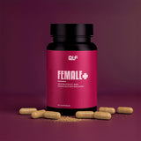 Eine Dose Female+ mit deutschem Text steht auf einer violetten Fläche, umgeben von beigen Kapseln und Pulver. Das dunkelrosa Etikett hebt dieses Nahrungsergänzungsmittel für gesunde Haut hervor und enthält 90 Kapseln.