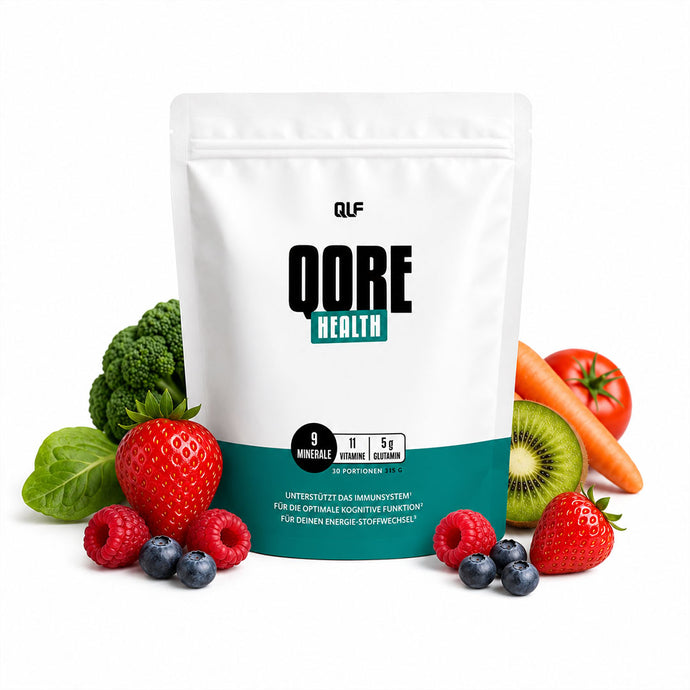 White pouch labeled QORE Health surrounded by fresh strawberries, raspberries, blueberries, kiwi, carrot, broccoli, spinach, and tomato