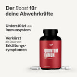 Eine Dose Quantum Immun mit Zink und Vitamin C steht neben den Kapseln. Der deutsche Text hebt die Unterstützung des Immunsystems ("Abwehrkräfte") und die Verkürzung der Dauer von Erkältungssymptomen hervor.