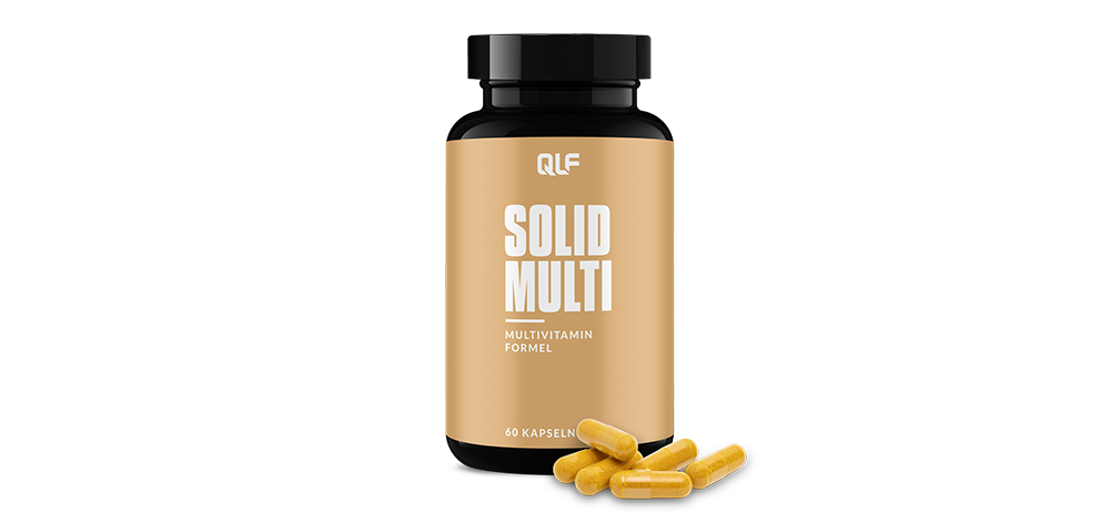 Black bottle labeled Solid Multi multivitamin with scattered yellow capsules in front on white background